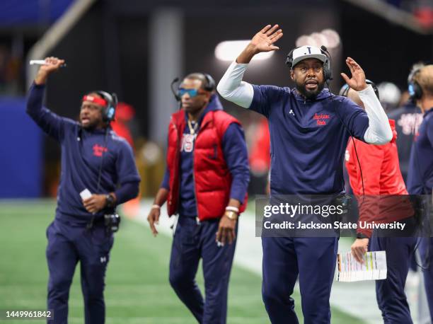 Incoming head coach TC Taylor, right, shouts as outgoing coach Deion Sanders looks on during the Jackson State Tigers and North Carolina Central...