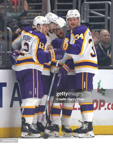 Phillip Danault of the Los Angeles Kings celebrates his goal with Trevor Moore and Arthur Kaliyev, to take a 1-0 lead over the San Jose Sharks during...