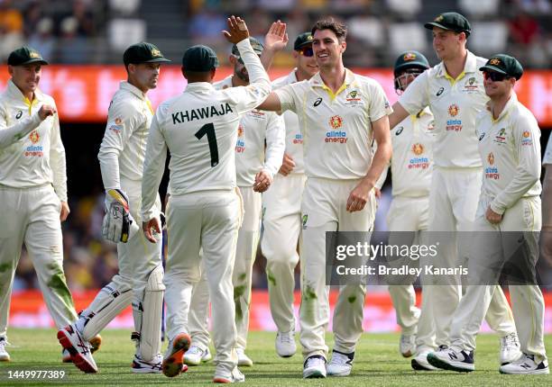 Pat Cummins of Australia celebrates taking the wicket of Kagiso Rabada of South Africa during day two of the First Test match between Australia and...