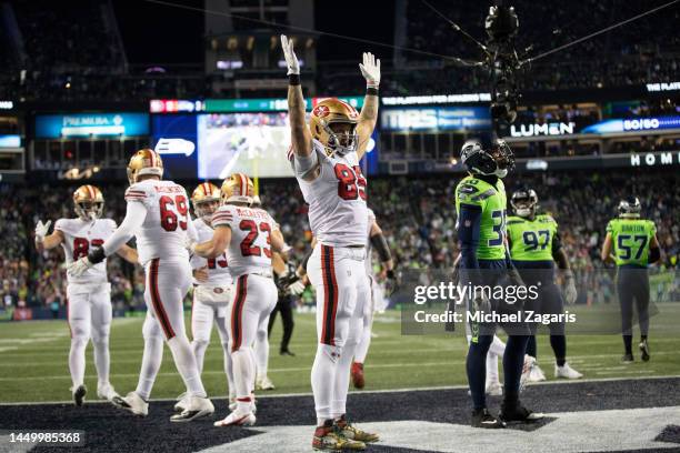 George Kittle of the San Francisco 49ers celebrates after Christian McCaffrey rushed for a touchdown during the game against the Seattle Seahawks at...