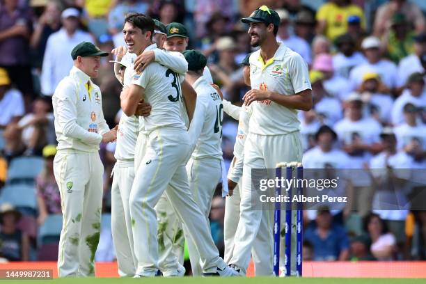 Australia celebrate a wicket during day two of the First Test match between Australia and South Africa at The Gabba on December 18, 2022 in Brisbane,...