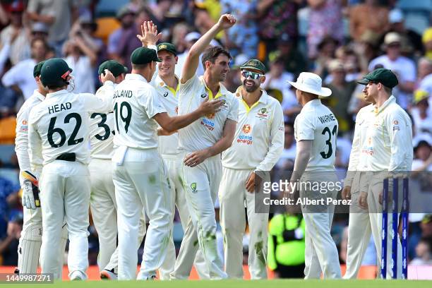Australia celebrate a wicket during day two of the First Test match between Australia and South Africa at The Gabba on December 18, 2022 in Brisbane,...