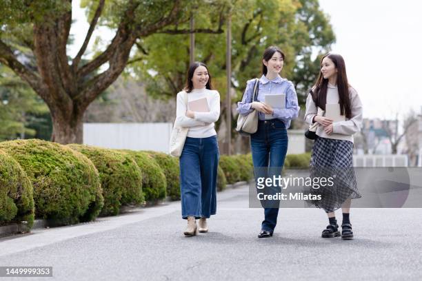portrait of a college student walking outside - 若い カワイイ 女の子 日本人 ストックフォトと画像