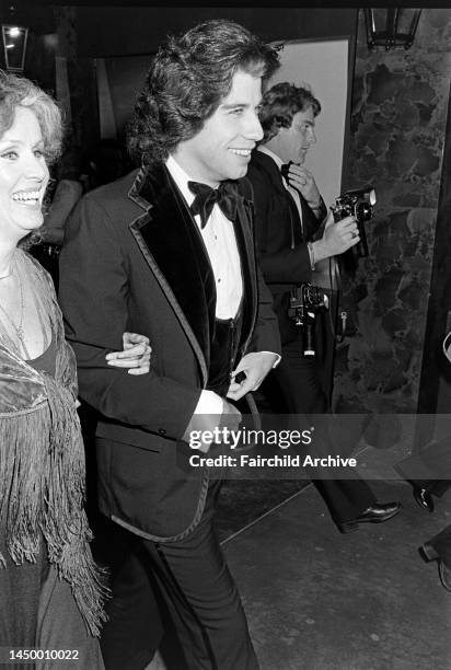 Diana Hyland and John Travolta attend an event at the Santa Monica Civic Auditorium in Santa Monica, California, on November 20, 1976.