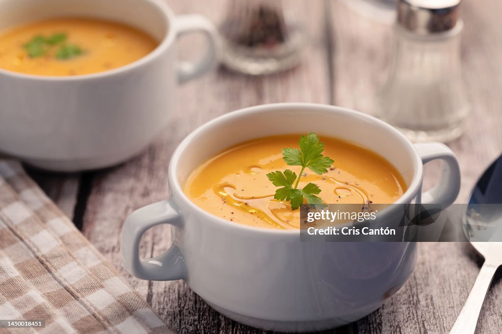 Pumpkin soup on wooden table