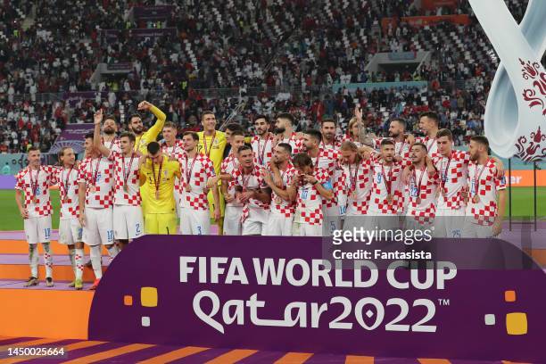 Luka Modric of Croatia kisses his medal as the Croatia team celebrates after the 3rd place medal ceremony following the final whistle of the FIFA...