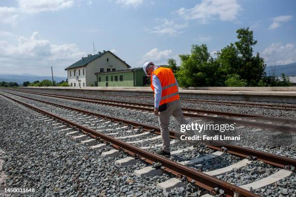 An employee of Kosovo Railways Company inspects the newly mounted railway tracks at the Gurez railway station on July 3, 2023 in Gurez village close...