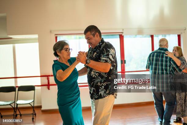 senior couples dancing at a class in a dance studio - swing dance stock pictures, royalty-free photos & images