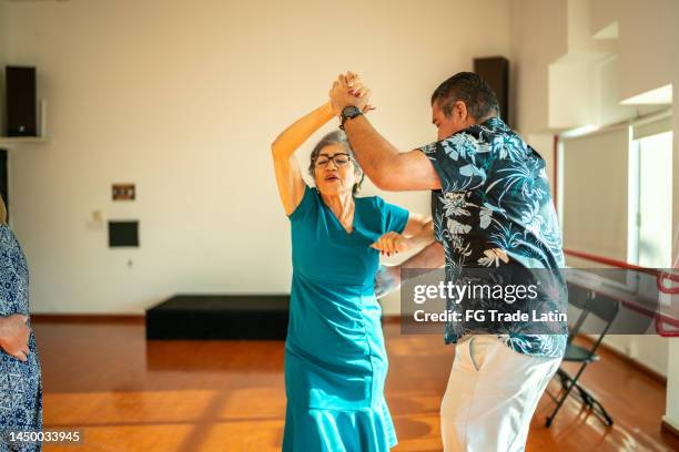 senior couple dancing at dance studio - ballroom dancers stock pictures, royalty-free photos & images