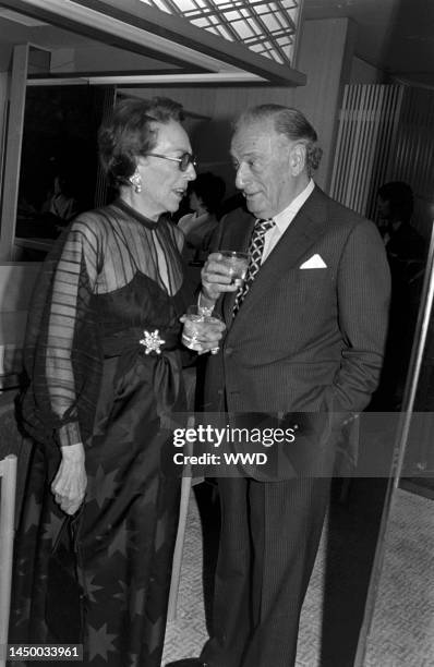 Socialite and theater producer Irene Mayer Selznick talks to film producer Sam Spiegel