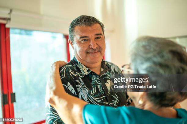 portrait of mature man dancing with wife at dance studio - older couple ballroom dancing stock pictures, royalty-free photos & images