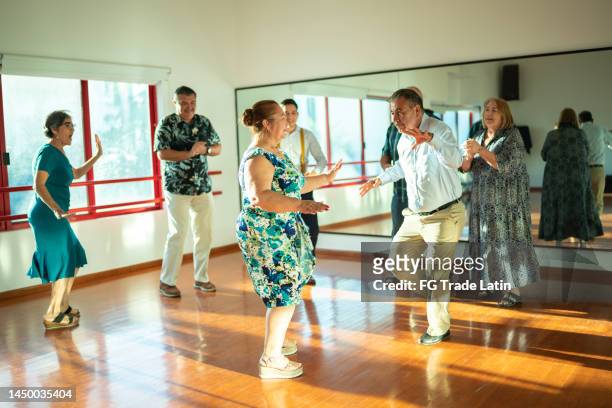 mature couple dancing at a dance studio - free pictures ballroom dancing stock pictures, royalty-free photos & images