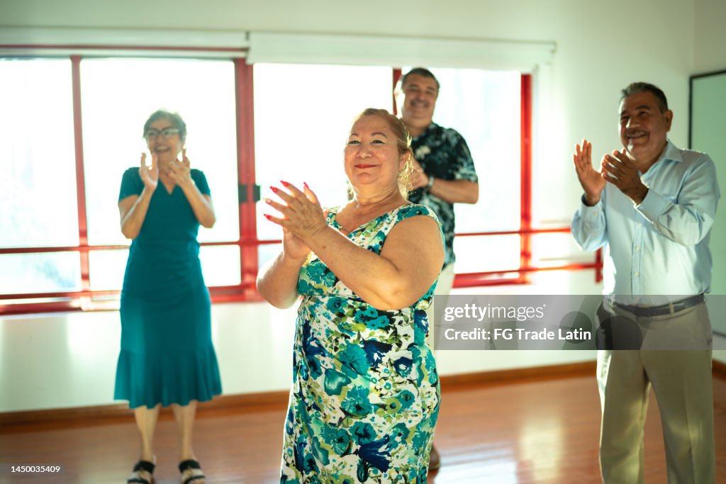 Mature students clapping at a dance studio