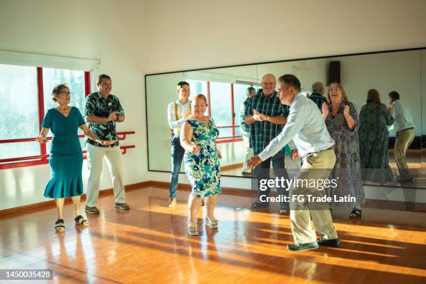 mature couple dancing at a dance studio - free pictures ballroom dancing stock pictures, royalty-free photos & images