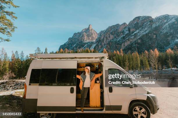 woman in camper van on the background of dolomites in autumn - motorhome france stock pictures, royalty-free photos & images