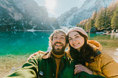 Selfie of man and woman near  Lago di Braies in winter
