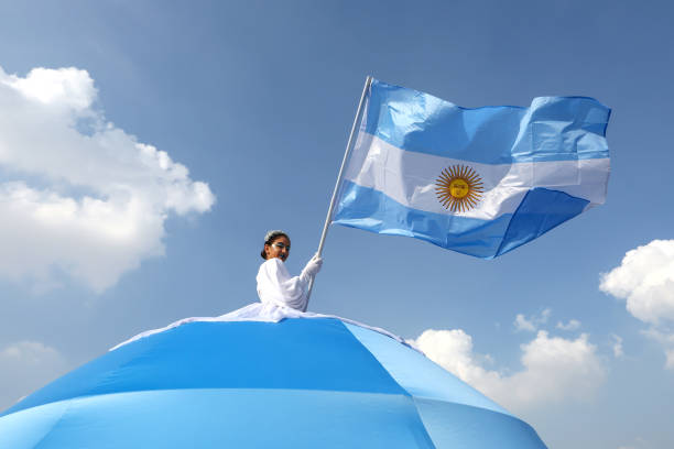 An artist waves a national flag of Argentina flag whilst performing outside the stadium prior to the FIFA World Cup Qatar 2022 Final match between...