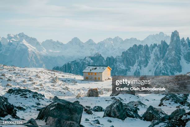 alpine shelter in snow-covered dolomites in winter - sheltering stock pictures, royalty-free photos & images