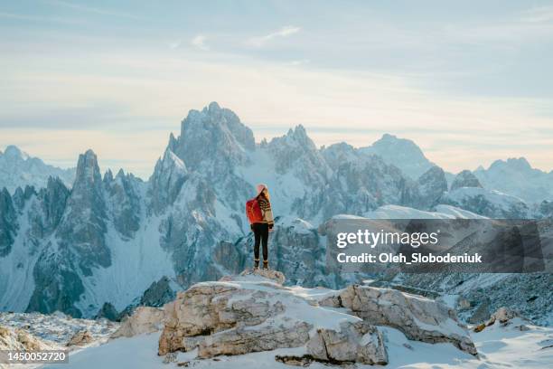 woman hiking  in snow-covered dolomites in winter - cortina stock pictures, royalty-free photos & images