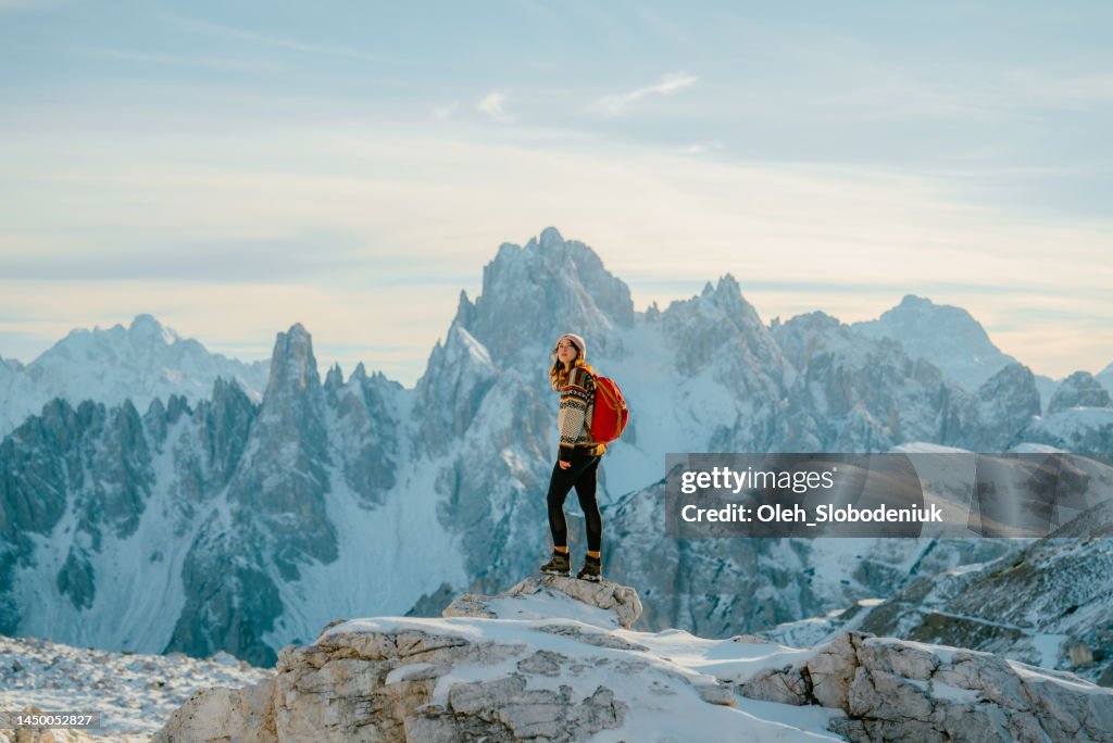 Woman hiking in snow-covered Dolomites in winter