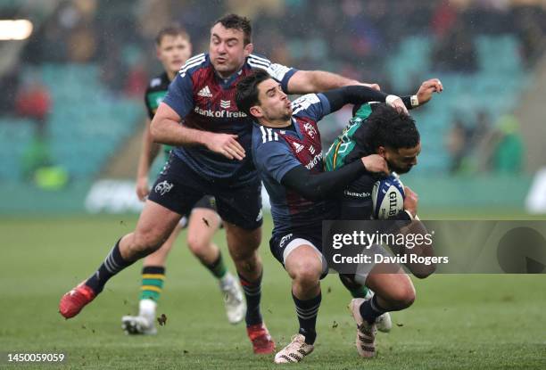 Matt Proctor of Northamptons Saints is tackled by Joey Carbery and Niall Scannell during the Heineken Cup Champions Cup match between Northampton...