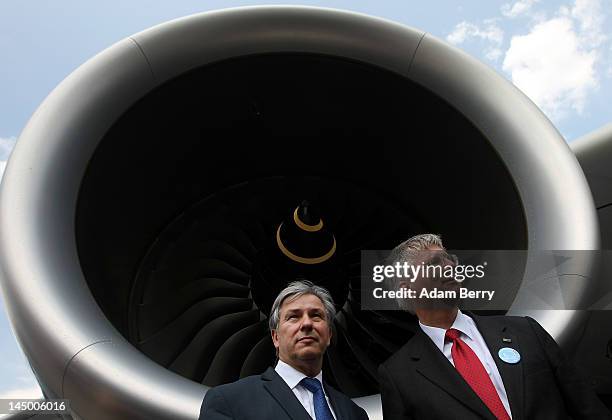 Klaus Wowereit, mayor of Berlin , stands with Christoph Franz, chief executive officer of Deutsche Lufthansa, in front of the engine of an Airbus...