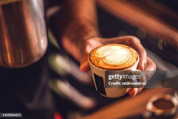man preparing coffee at table in cafe - latte barista stock pictures, royalty-free photos & images