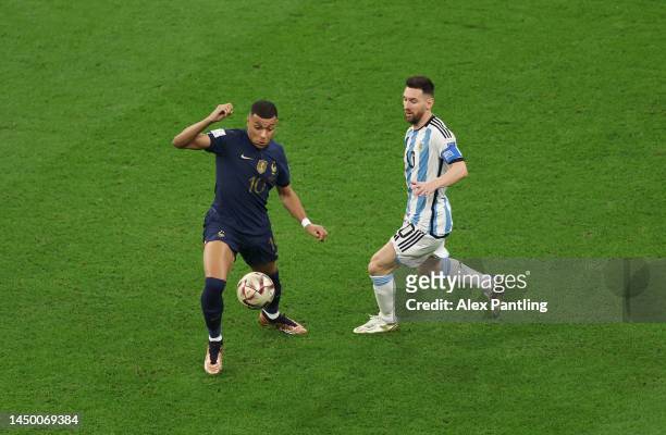 Kylian Mbappe of France controls the ball against Lionel Messi of Argentina during the FIFA World Cup Qatar 2022 Final match between Argentina and...