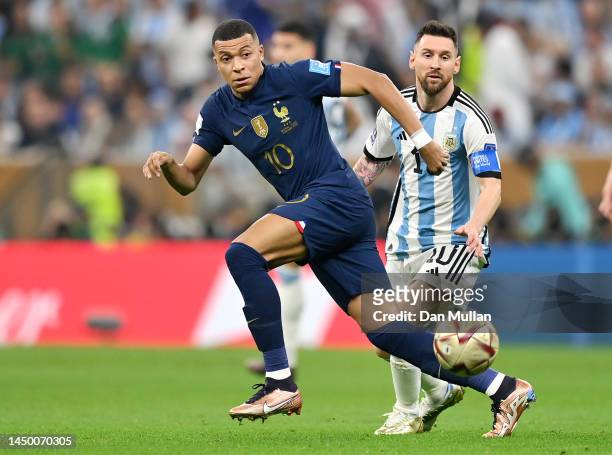 Kylian Mbappe of France battles for possession with Lionel Messi of Argentina during the FIFA World Cup Qatar 2022 Final match between Argentina and...