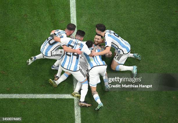 Lionel Messi of Argentina celebrates with teammates after scoring the team's first goal via a penalty during the FIFA World Cup Qatar 2022 Final...