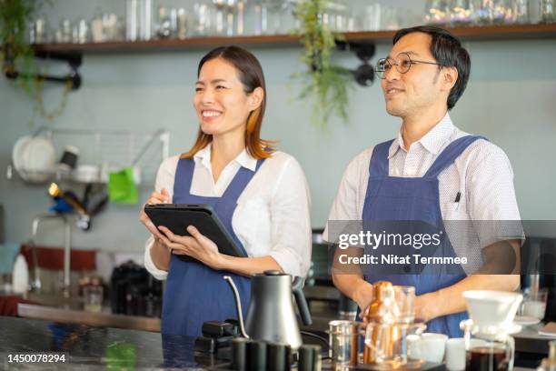 good customer experience is everything to increase of  your sales. a japanese coffee shop owner and employee at the cashier counter of a cafe say "welcome back and it's great to see you again." to customers. customer appreciation and customer serving. - great customer service stock pictures, royalty-free photos & images
