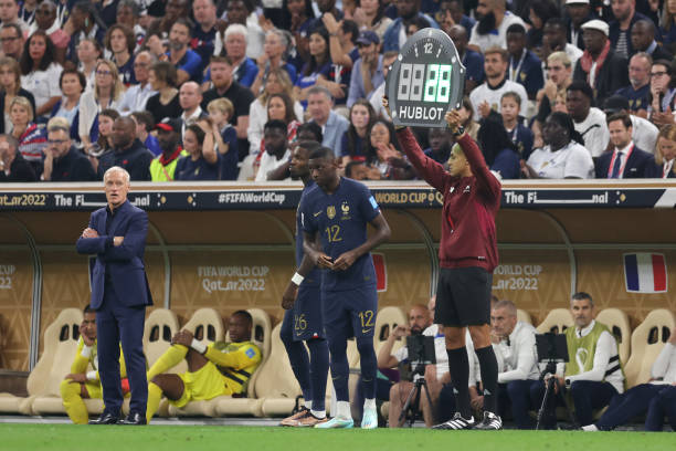 Marcus Thuram and Randal Kolo Muani of France wait to be substituted as head coach Didier Deschamps looks on during the FIFA World Cup Qatar 2022...
