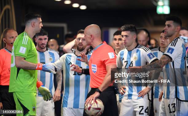 Referee Szymon Marciniak walks past Argentina players in the tunnel before the second half the FIFA World Cup Qatar 2022 Final match between...