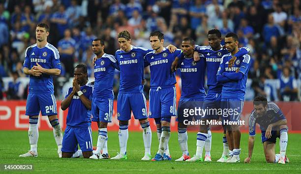 Didier Drogba of Chelsea prays as his team mates look on in the penalty shoot out during UEFA Champions League Final between FC Bayern Muenchen and...