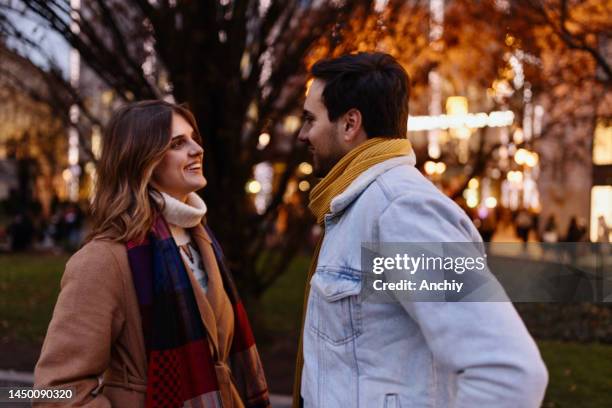 young couple on a date enjoying city life - date night stock pictures, royalty-free photos & images