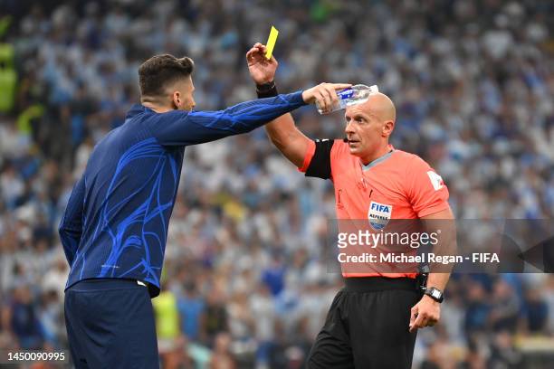 Olivier Giroud of France is shown a yellow card by referee Szymon Marciniak during the FIFA World Cup Qatar 2022 Final match between Argentina and...