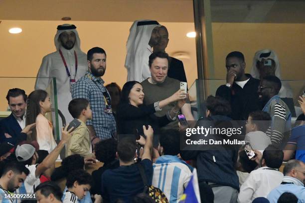 Fans take photos with Elon Musk during the FIFA World Cup Qatar 2022 Final match between Argentina and France at Lusail Stadium on December 18, 2022...
