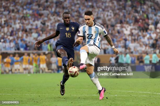 Dayot Upamecano of France battles for possession with Lautaro Martinez of Argentina during the FIFA World Cup Qatar 2022 Final match between...