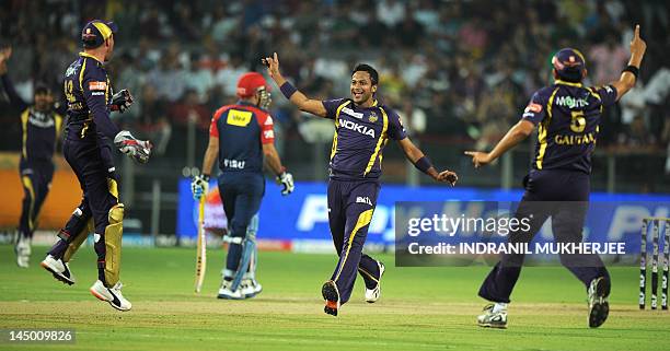 Kolkata Knight Riders cricketers Brendon McCullum , bowler Shakib Al Hasan and captain Gautam Gambhir celebrate the wicket of Delhi Daredevils...