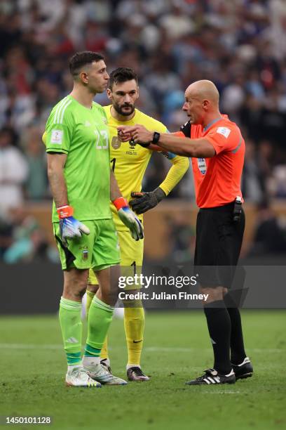 Referee Szymon Marciniak talks to Emiliano Martinez of Argentina and Hugo Lloris of France before the penalty shootout during the FIFA World Cup...