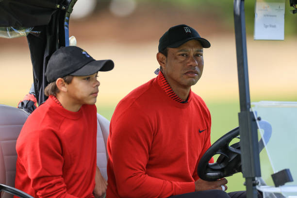 Tiger Woods of The United States rides a cart with his son Charlie Woods on the third hole during the final round of the 2022 PNC Championship at The...