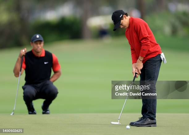 Tiger Woods of The United States watches his son Charlie Woods putt on the second hole during the final round of the 2022 PNC Championship at The...