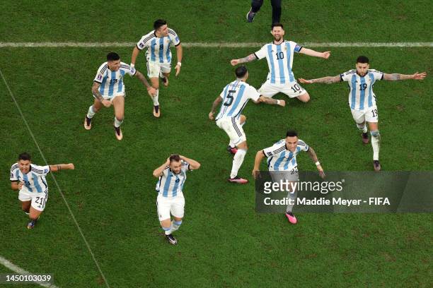 Lionel Messi of Argentina and teammates celebrate the fourth and winning penalty by Gonzalo Montiel in the penalty shootout during the FIFA World Cup...