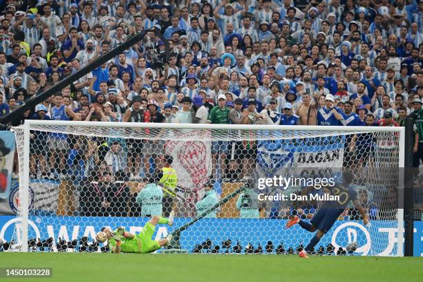 Emiliano Martinez of Argentina saves the second penalty from Kingsley Coman of France in the penalty shoot out during the FIFA World Cup Qatar 2022...