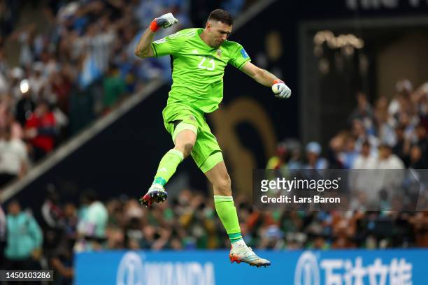 Emiliano Martinez of Argentina celebrates after saving the second penalty from Kingsley Coman of France in the penalty shoot out during the FIFA...