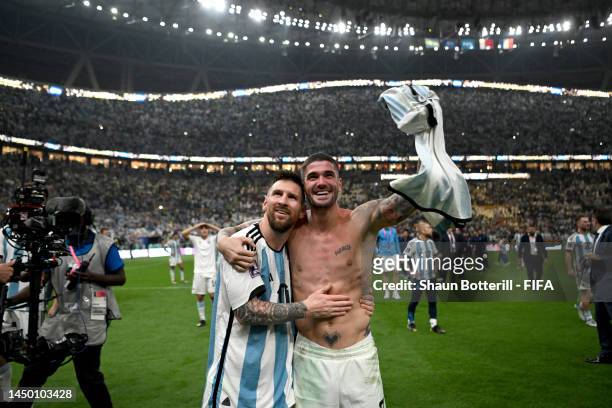 Lionel Messi and Rodrigo De Paul of Argentina celebrate with the fans after the team's victory in the penalty shoot out during the FIFA World Cup...