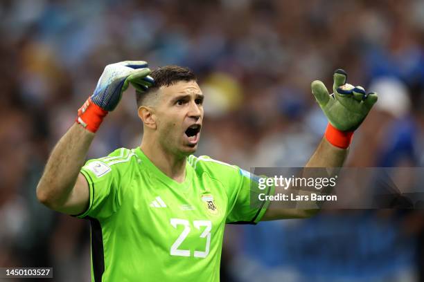 Emiliano Martinez of Argentina celebrates saving the second penalty from Kingsley Coman of France in the penalty shoot out during the FIFA World Cup...