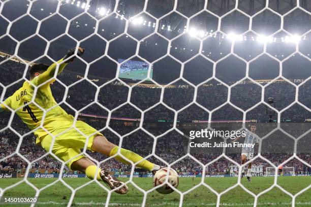 Paulo Dybala of Argentina scores the team's second penalty past Hugo Lloris of France in the penalty shoot out during the FIFA World Cup Qatar 2022...