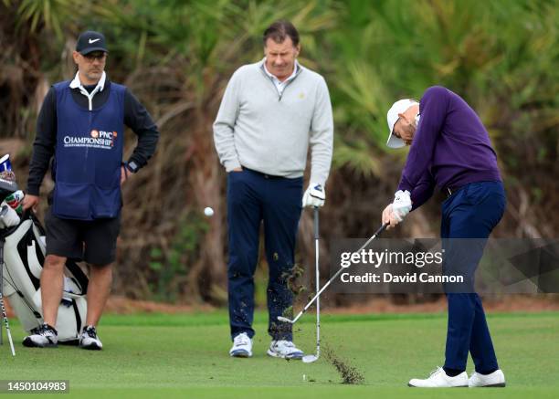 Sir Nick Faldo of England watches his son Matthew Faldo play his second shot on the first hole during the final round of the 2022 PNC Championship at...