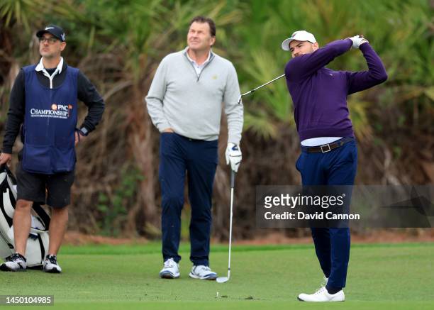 Sir Nick Faldo of England watches his son Matthew Faldo play his second shot on the first hole during the final round of the 2022 PNC Championship at...